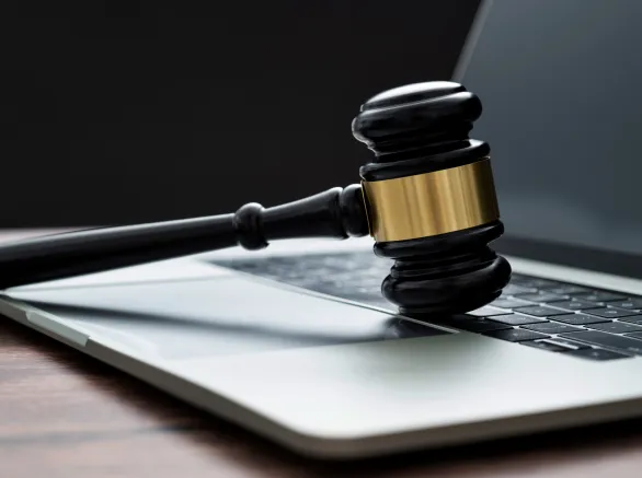 Gavel and laptop on the table