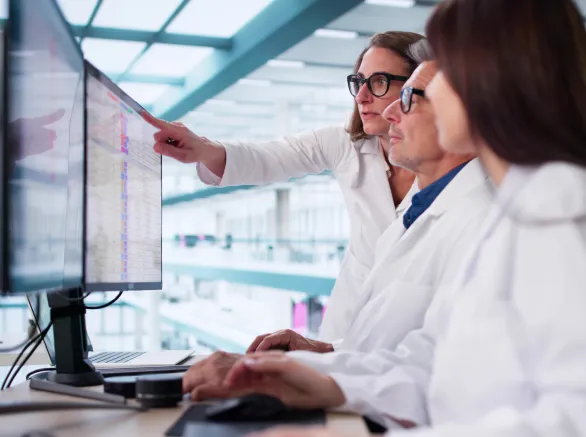 Busy Healthcare Team Using Medical Billing Coding Software In Hospital.