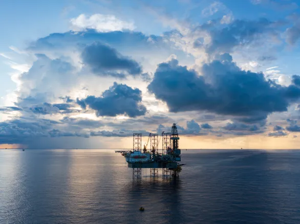 Offshore jack up rig in aerial view in the middle of the ocean taken by a drone