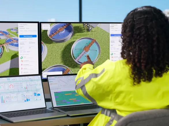 Woman Engineer Uses Computer To Monitor Water Treatment System Quality.