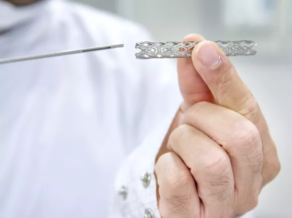 Man holds heart stent 