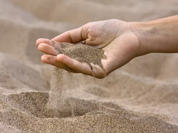 Sand running through fingers