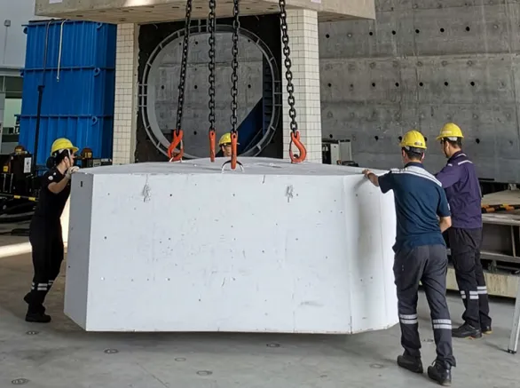 Labors moving huge concrete in a construction site