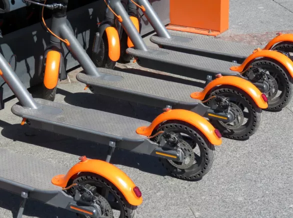 A line of e-scooters parked outside