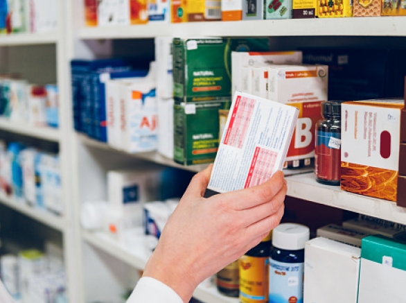 Pharmacist Arranges Medicines On The Shelves Of The Pharmacy