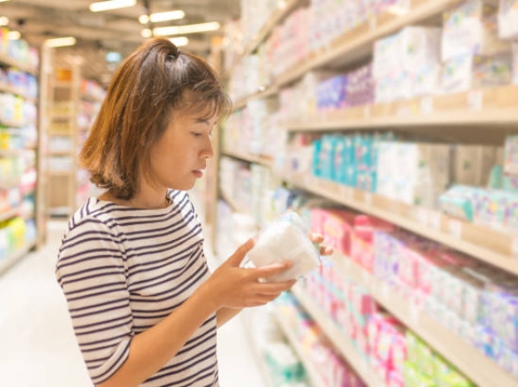 Asian Woman Shopping Sanitary Napkin At The Supermarket