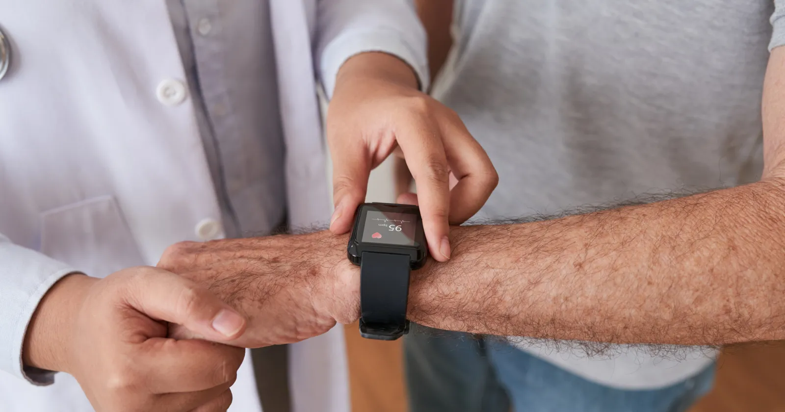 Doctor helping patient use a smart watch