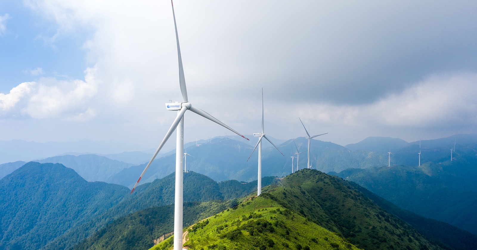 Wind turbines on a mountain range. Exponent's Environment & Sustainability expertise helps you make informed decisions.