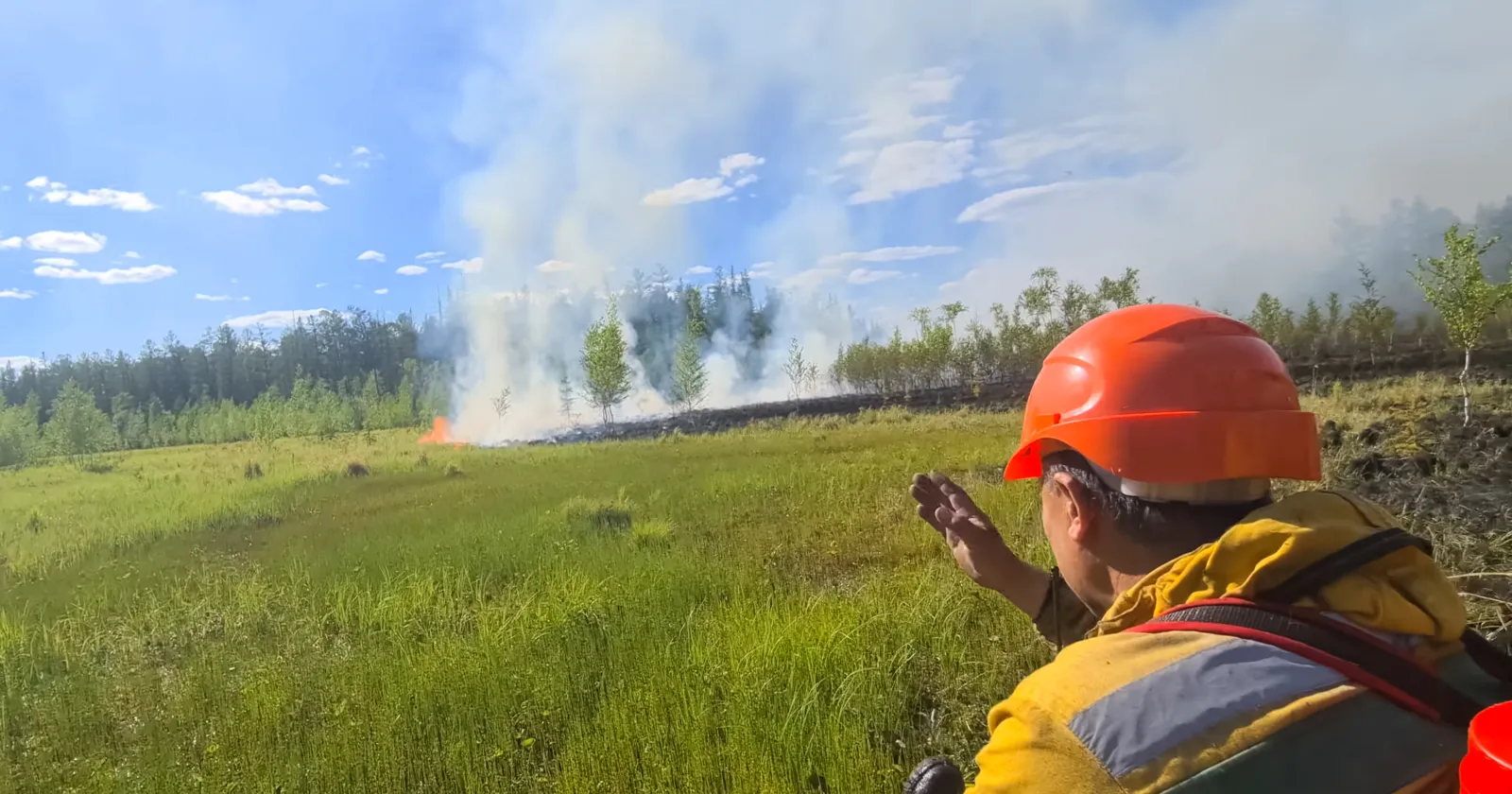 Firefighter shows his hand the direction of movement to the fire