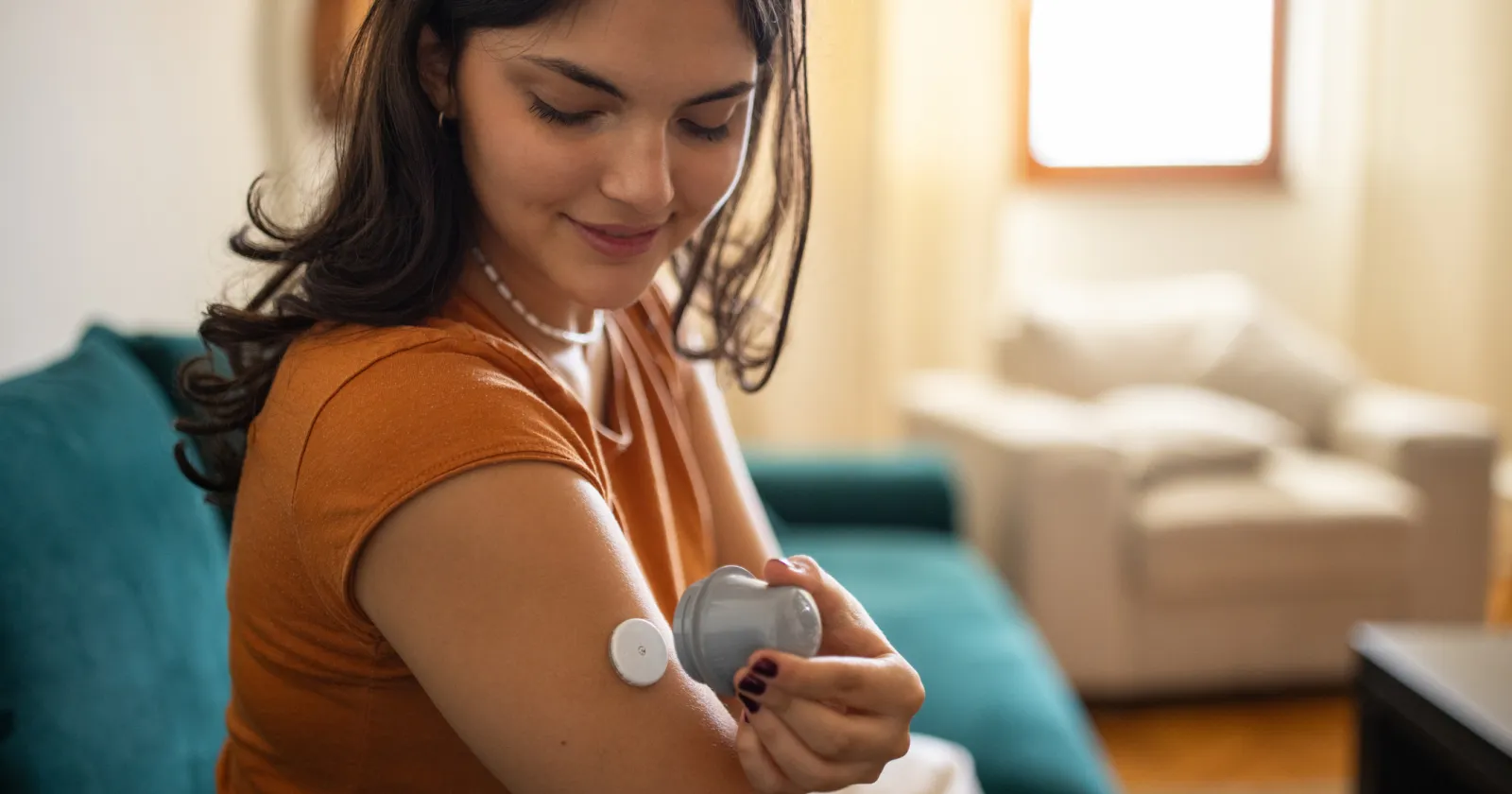 diabetic patient using glucose sensor on arm