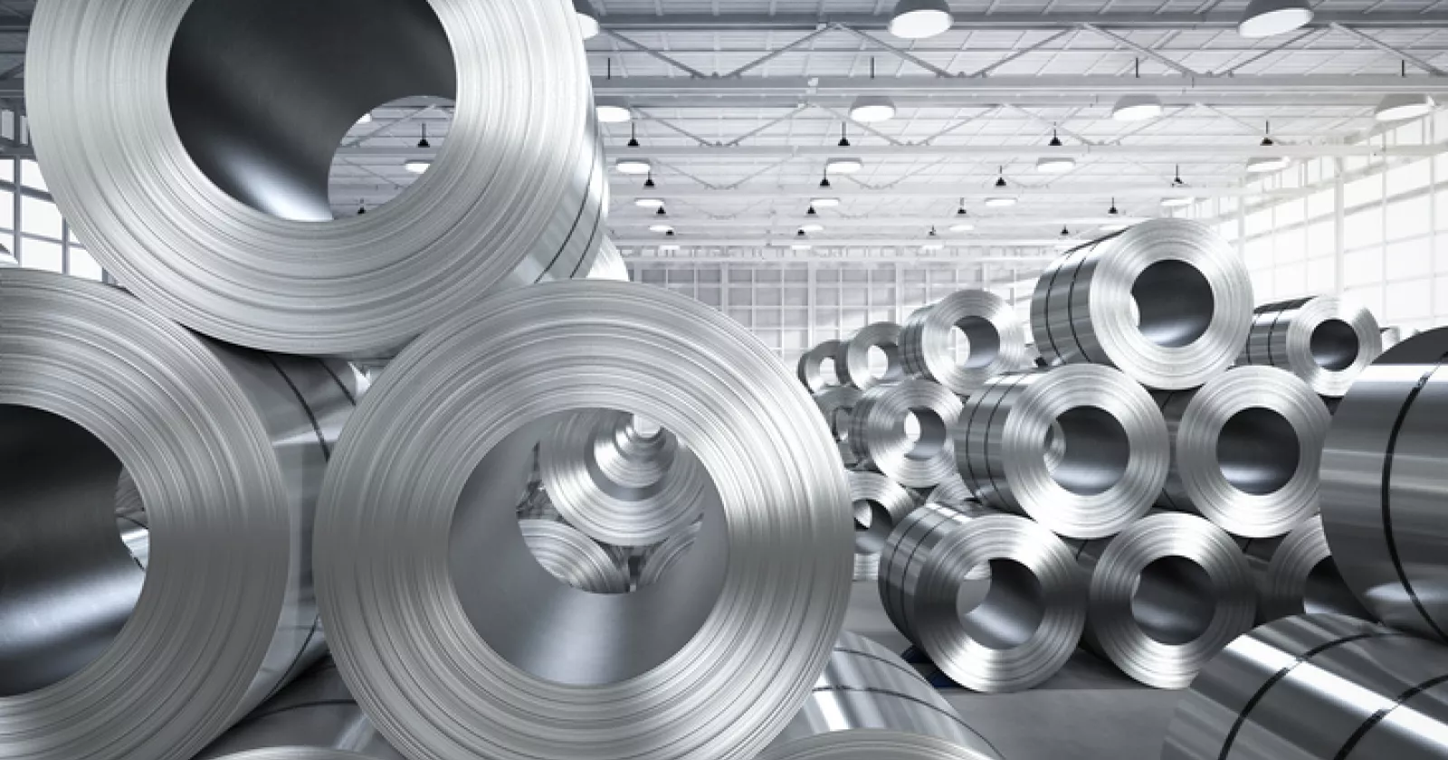 Large rolls of industrial steel in a factory setting. Exponent engineers help with all types of industrial & manufacturing challenges.