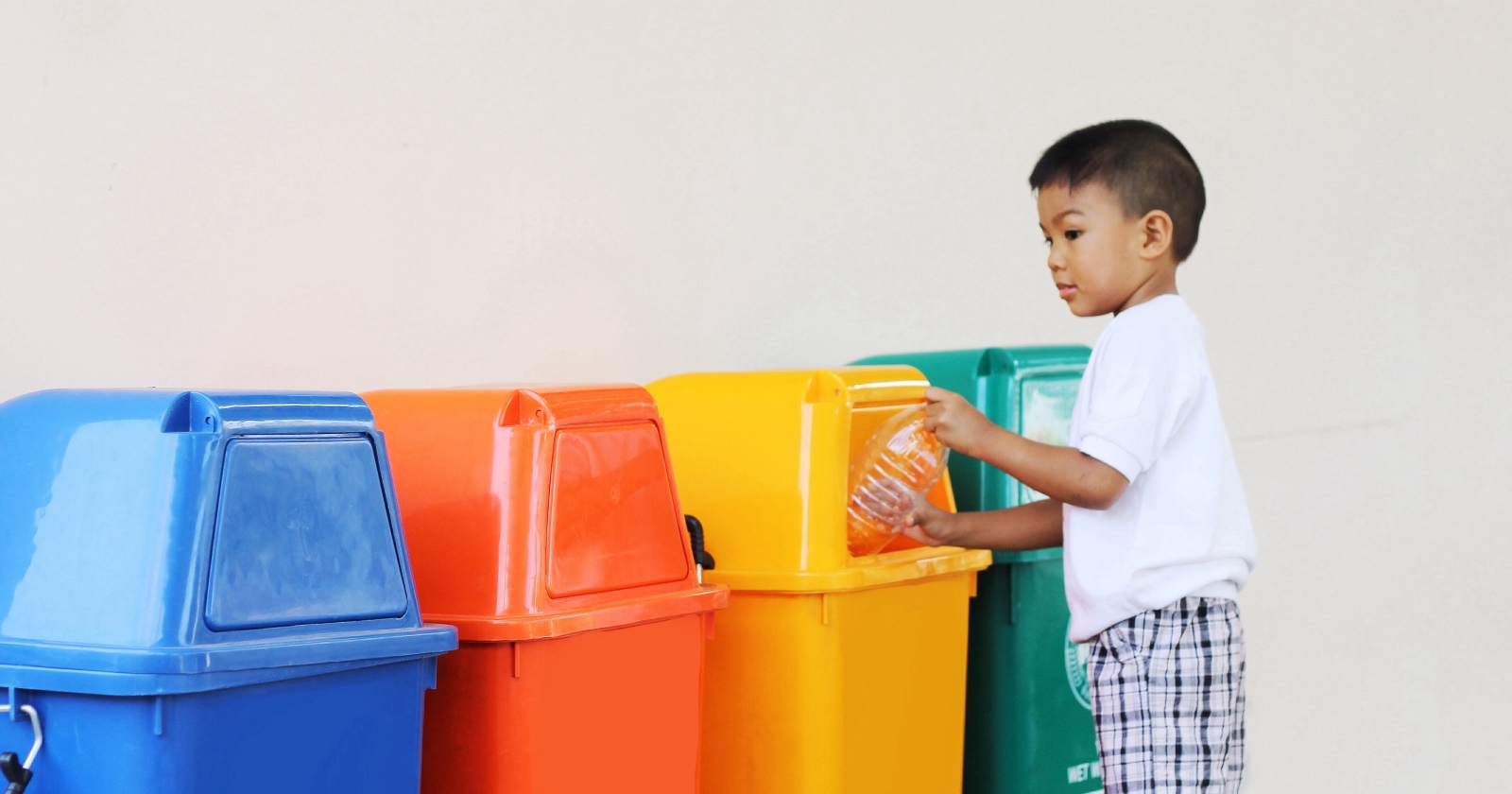 Boy recycling plastic