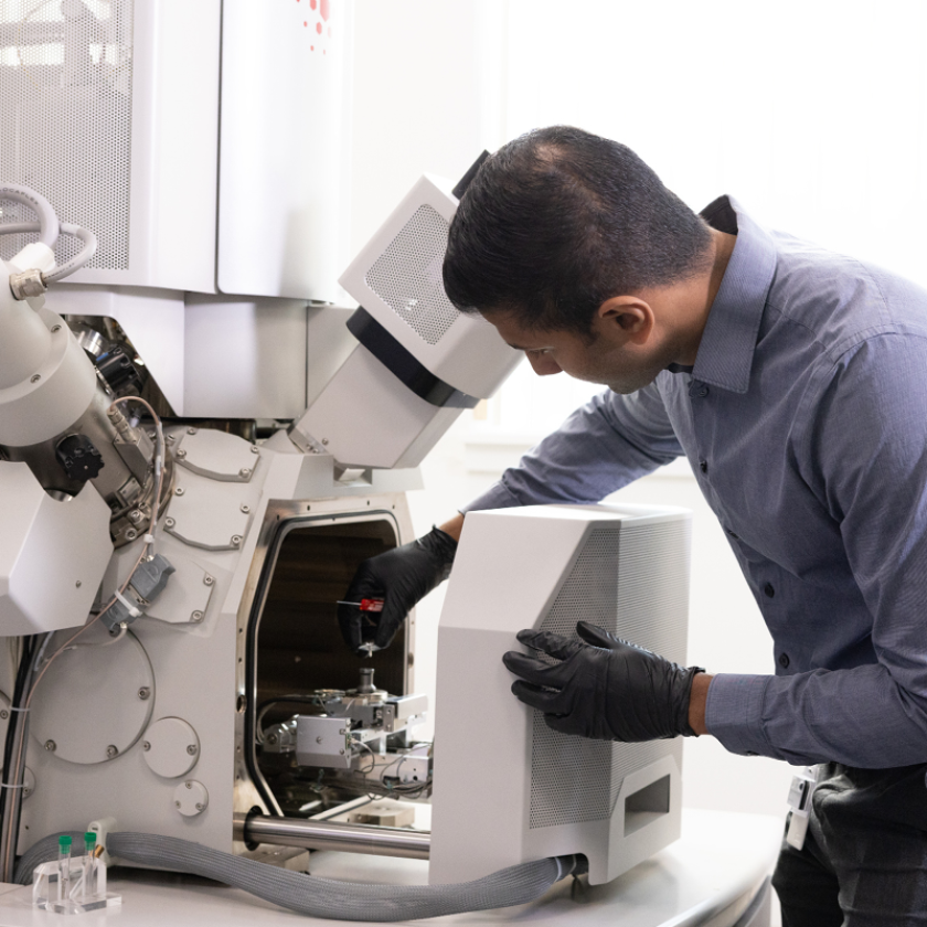 A man operating a FIB machine in a laboratory