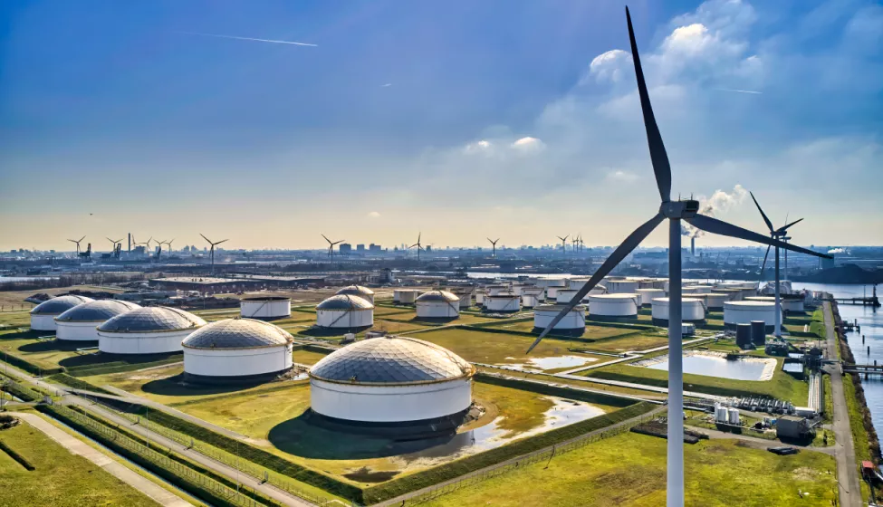 Aerial view of an energy facility with multiple windmills and domes