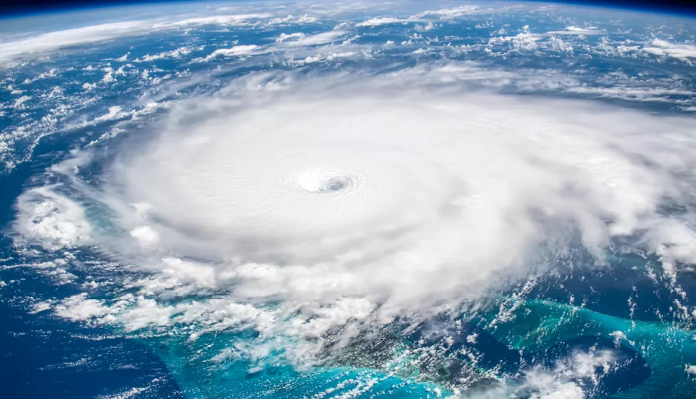 Satellite view of white swirling storm clouds forming over the earth's atmosphere