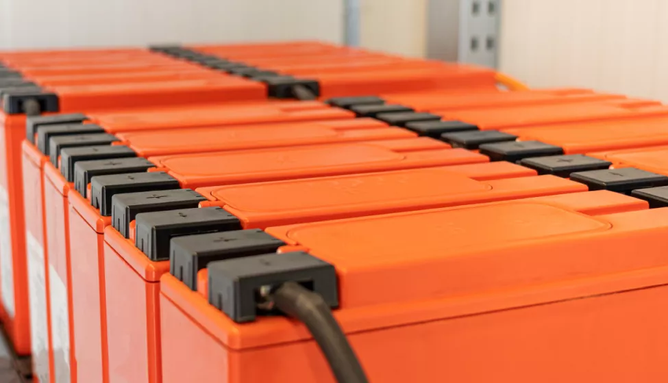 Two large orange battery energy storage systems (BESS) 
