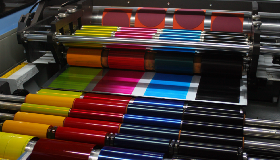 Rolls of colorful printing labels in printing press