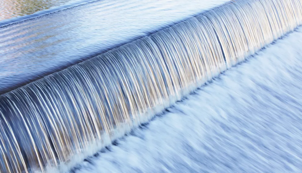 Water cascading over a very short wall in a dam