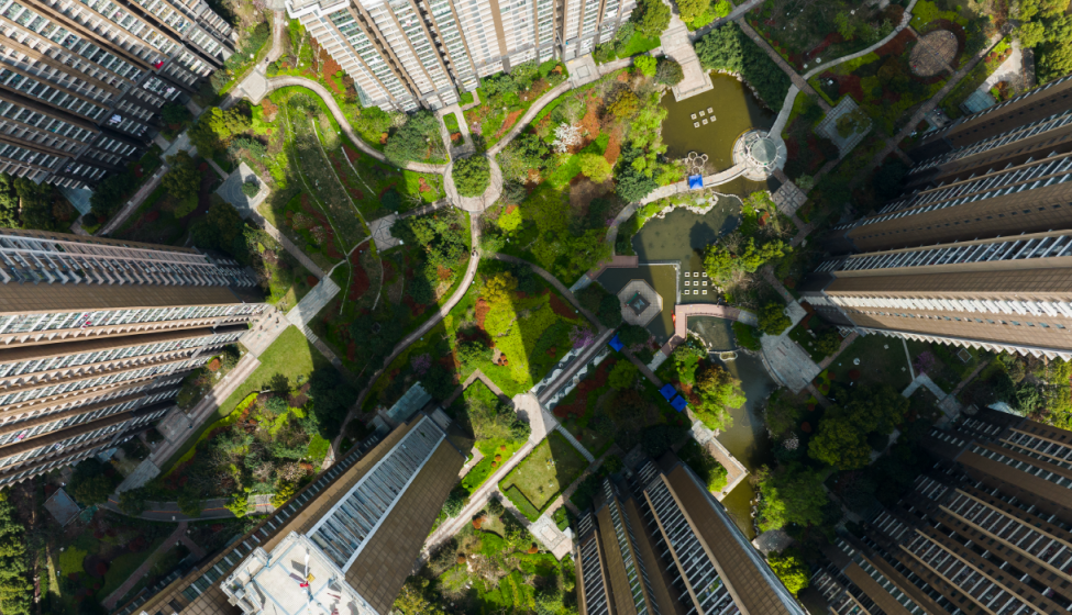 Aerial view of green space between 7 high-rise apartment buildings