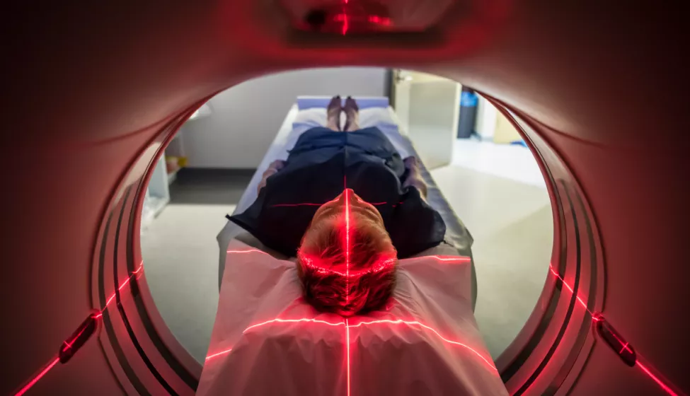 A patient laying down getting a CT scan