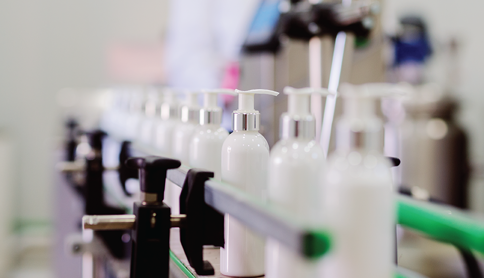 Picture of lotion bottles on production line.