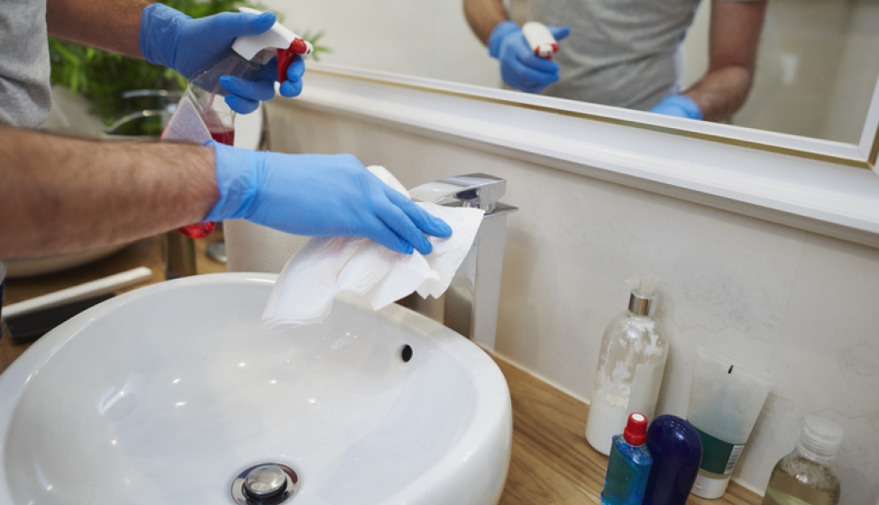 Using chemical to clean a bathroom sink. Exponent analyzes and helps improve safety and performance of household chemicals. 