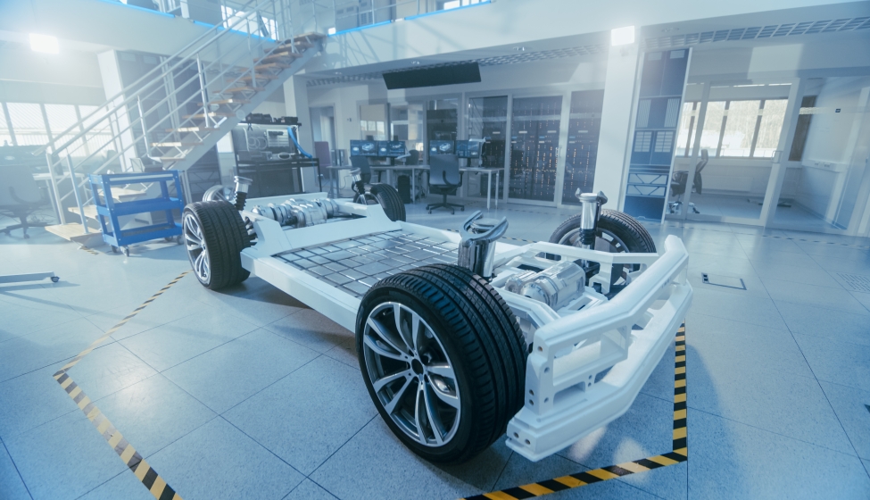 Electric Car Platform Prototype Standing in High Tech Industrial Machinery Design Laboratory. Hybrid Frame include Tires, Suspension, Engine and Battery.