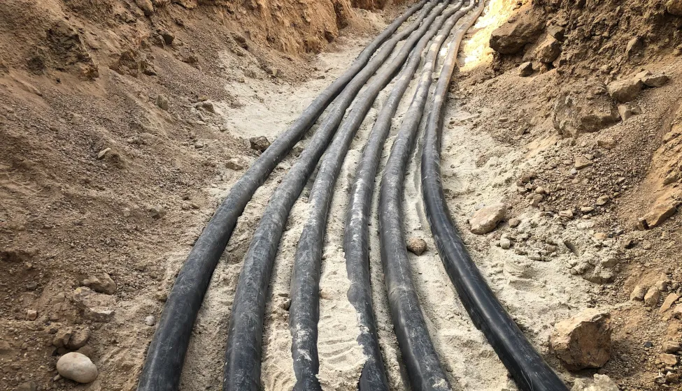 The high voltage electrical cable is laid in a trench