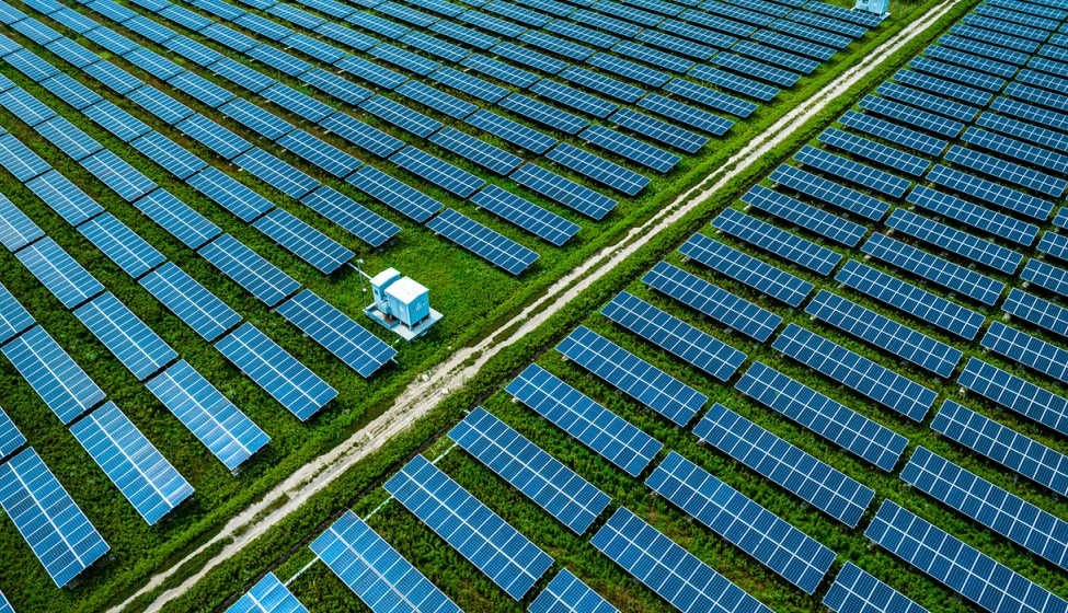 A field filled with a grid of multiple solar panels