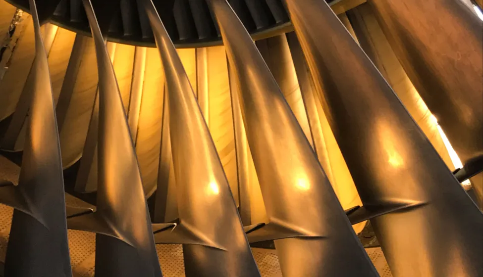 An illuminated jet engine in golden colors