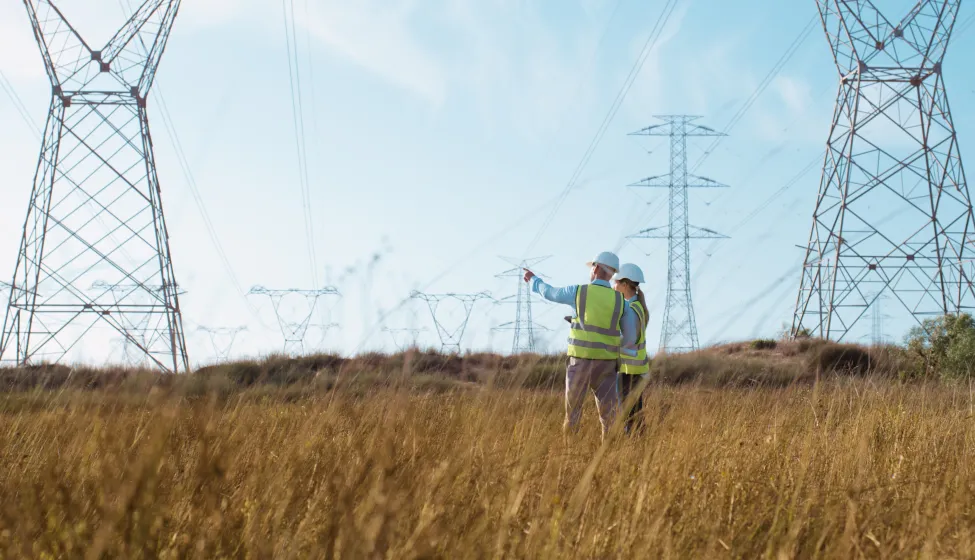 Teamwork, electrical engineer and inspection in power station with people for electricity transmission and tower check. Engineering, back and collaboration for energy distribution or mockup in field 