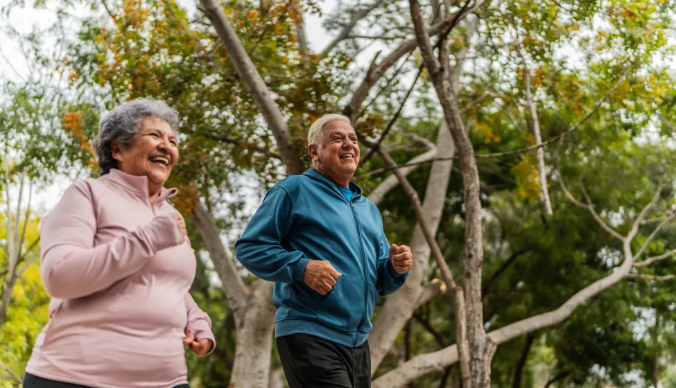 Senior couple talking and running on public park