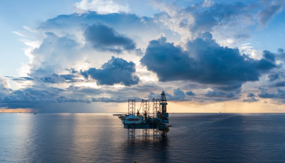 Offshore jack up rig in aerial view in the middle of the ocean taken by a drone