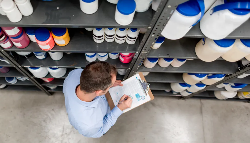 Man doing an inventory at a chemical warehouse 