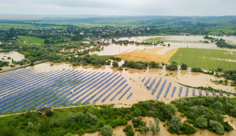 Aerial view of flooded solar power station with dirty river water in rain season