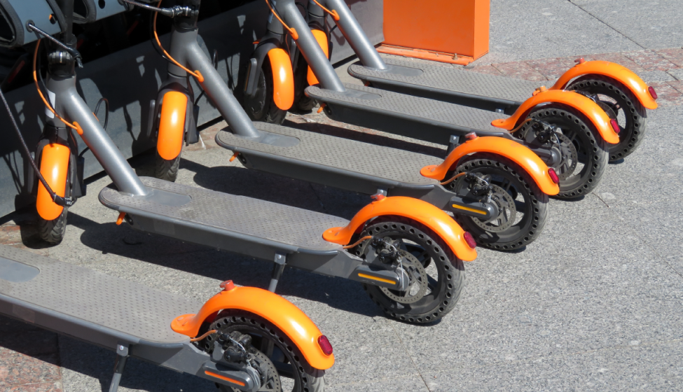 A line of e-scooters parked outside 