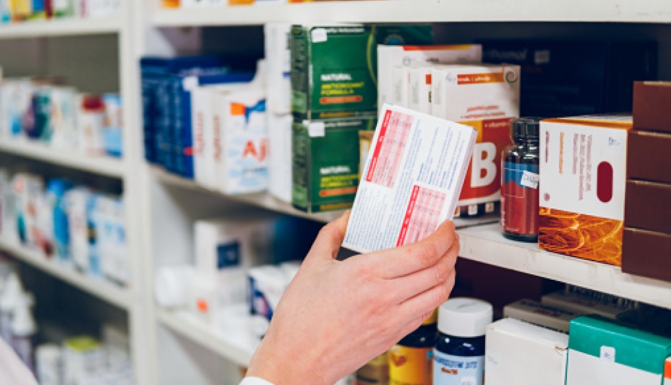 Pharmacist Arranges Medicines On The Shelves Of The Pharmacy