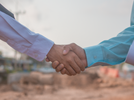 Businesspeople shaking hands in agreement. Exponent engineering expertise for construction disputes.
