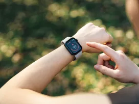 A runner checks their smartwatch. Exponent helps manufacturers develop safer and more innovative health monitoring and wearable devices.