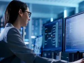  Close-up Shot of Female IT Engineer Working in Monitoring Room. She Works with Multiple Displays.
