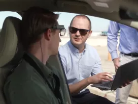 A man consults with an automotive tester
