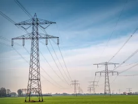 Large powerlines in a rural farm setting. Exponent helps stakeholders explore safer, more efficient and alternative energy solutions. 