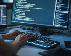 Close-up Focus on Person's Hands Typing on the Desktop Computer Backlit Keyboard