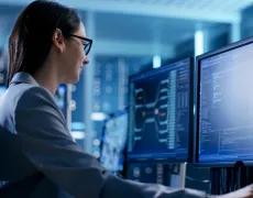  Close-up Shot of Female IT Engineer Working in Monitoring Room. She Works with Multiple Displays.