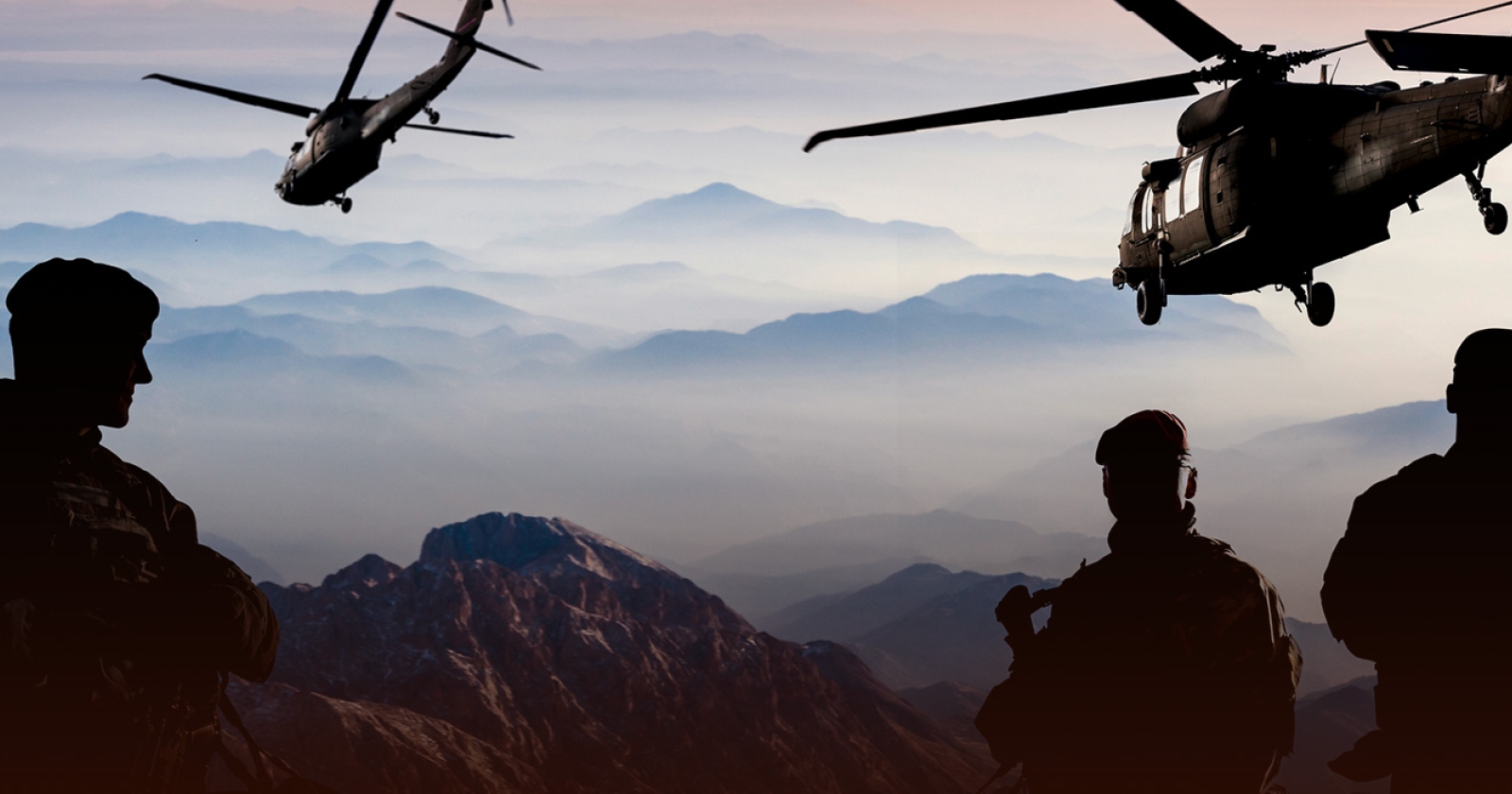 Military personnel in the mountains with helicopters flying above. We help industries leverage technology.