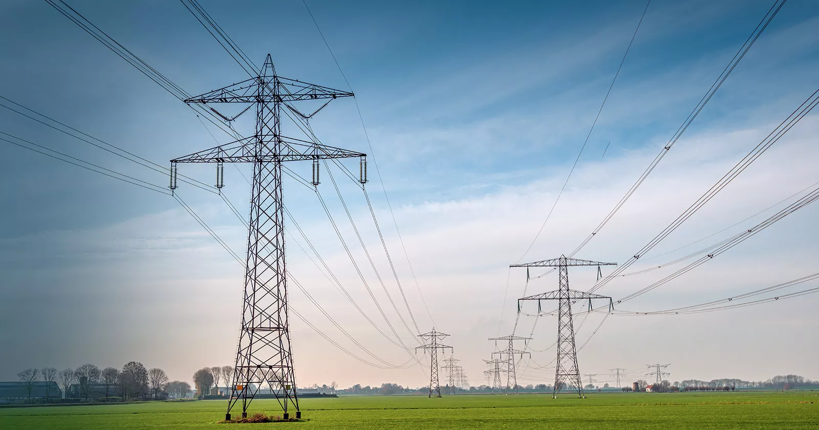 Large powerlines in a rural farm setting. Exponent helps stakeholders explore safer, more efficient and alternative energy solutions.